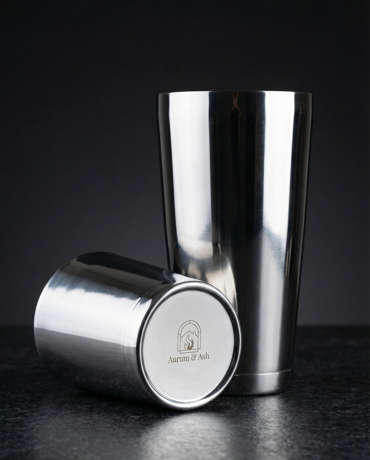 Two-piece Boston Shaker in stainless steel, large tin upright with the smaller tin showing the Aurum & Ash logo on the base.