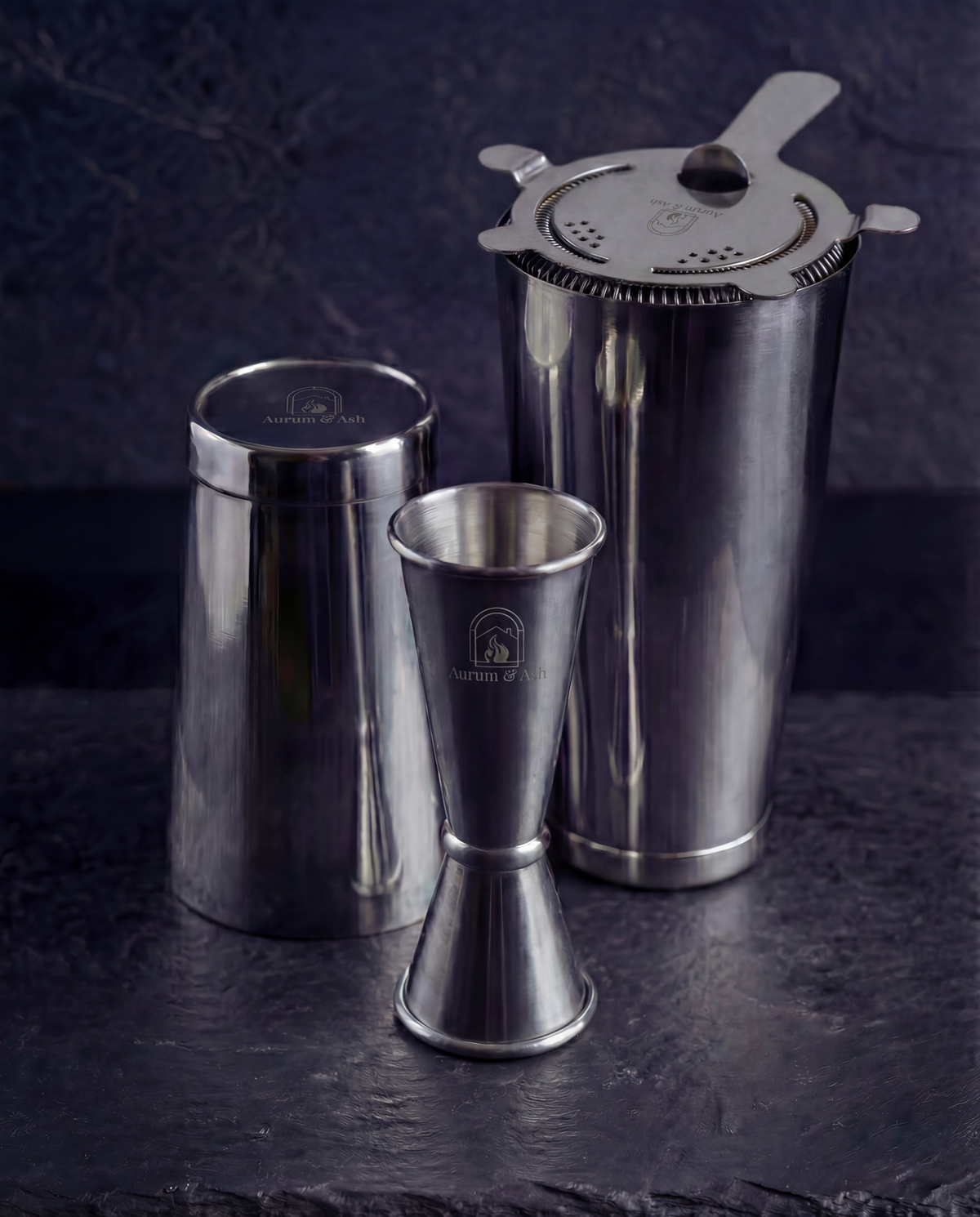 The Shaken Set: Boston Shaker tins with the Hawthorne Strainer on top and the Jigger in the foreground.