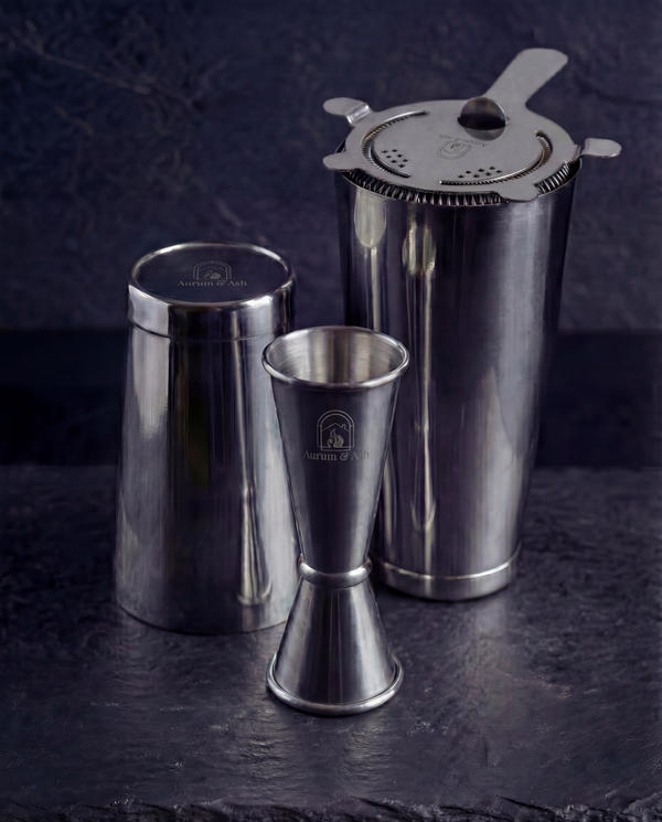 The Shaken Set: Boston Shaker tins with the Hawthorne Strainer on top and the Jigger in the foreground.