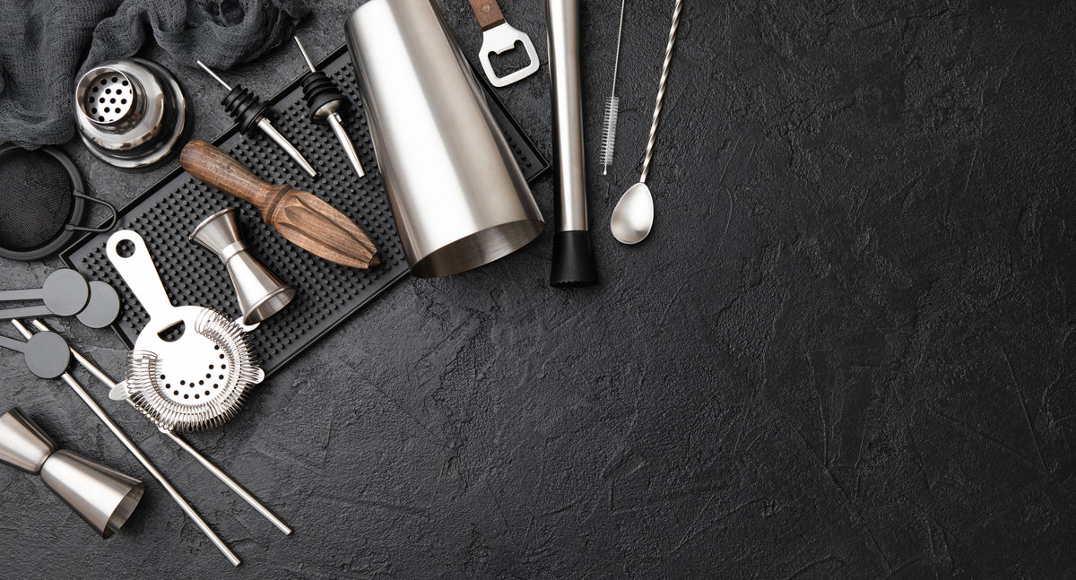Bartending tools on a dark surface